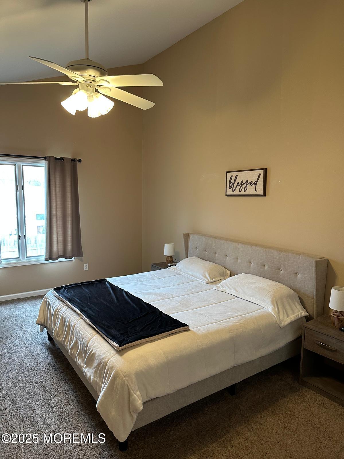 49 White Swan Way Brick, NJ 08723 - Photo 26 of 30 a bedroom with a bed and a chandelier