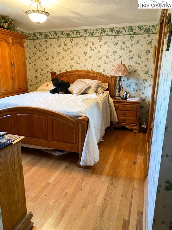 7874 Flat Ridge Road Troutdale, VA 24378 - Photo 18 of 37 a bedroom with a bed and a flat screen tv