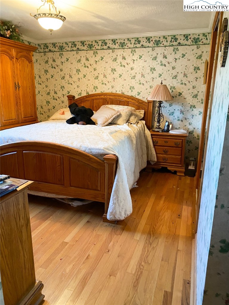 7874 Flat Ridge Road Troutdale, VA 24378 - Photo 18 of 37 a bedroom with a bed and wooden floor