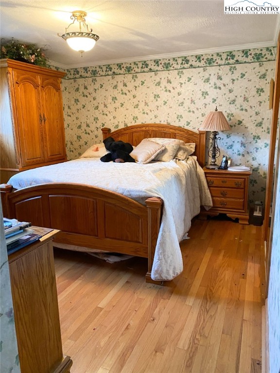 7874 Flat Ridge Road Troutdale, VA 24378 - Photo 19 of 37 a bed sitting in a room next to a lamp