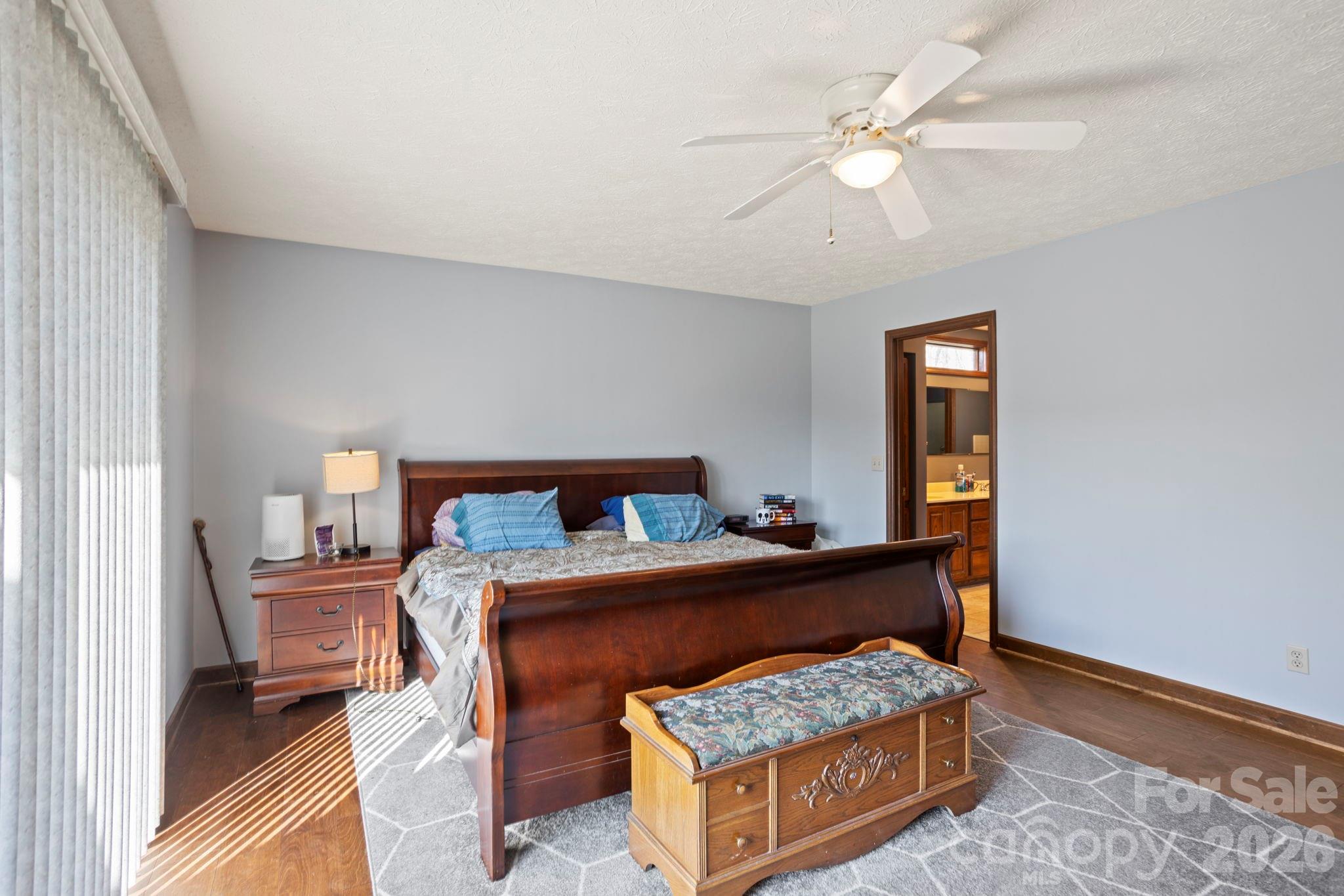 404 Browning Road Hendersonville, NC 28791 - Photo 17 of 46 a bedroom with a bed and a chandelier