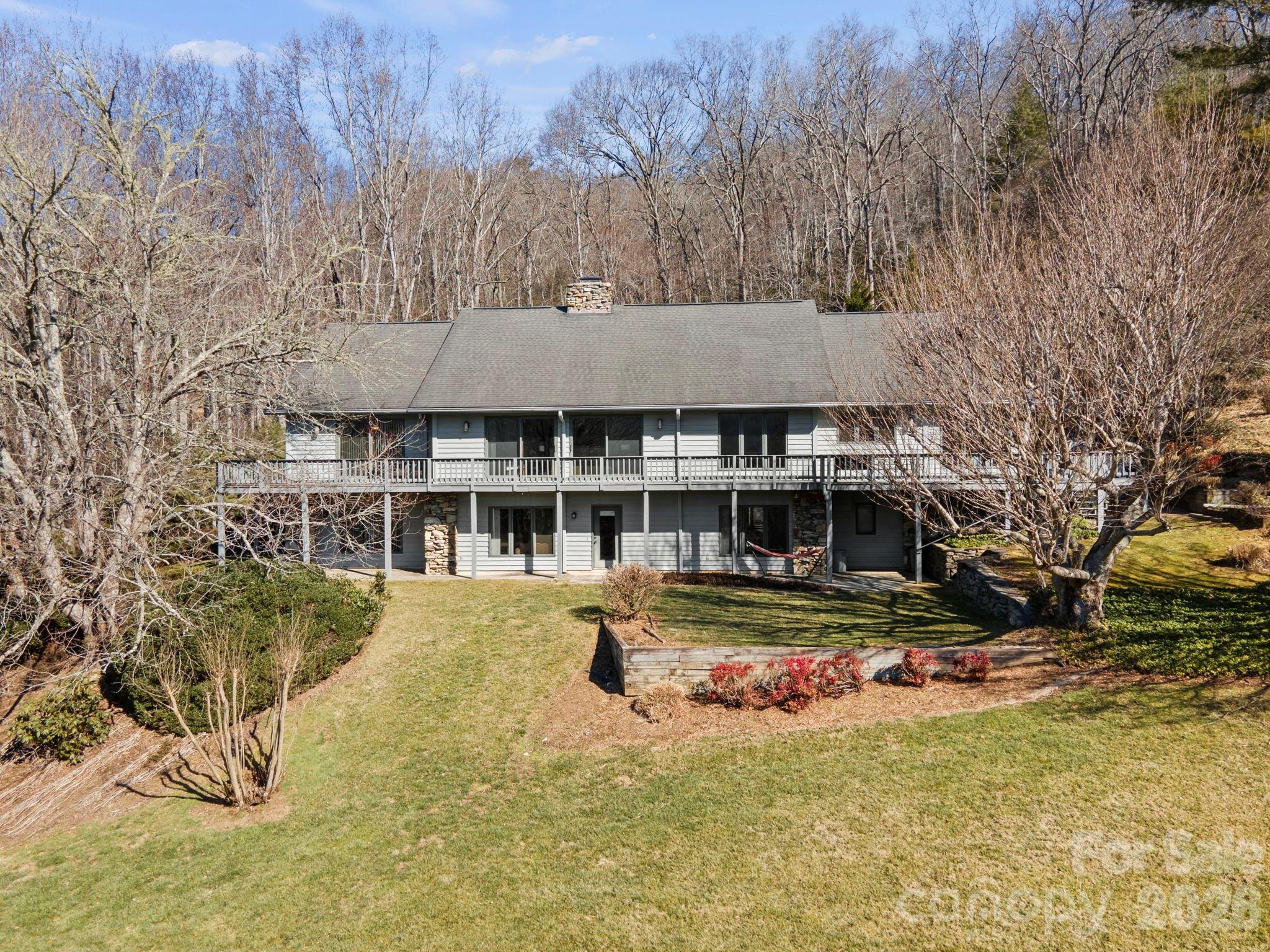 404 Browning Road Hendersonville, NC 28791 - Photo 2 of 46 a view of swimming pool with outdoor seating and covered with trees