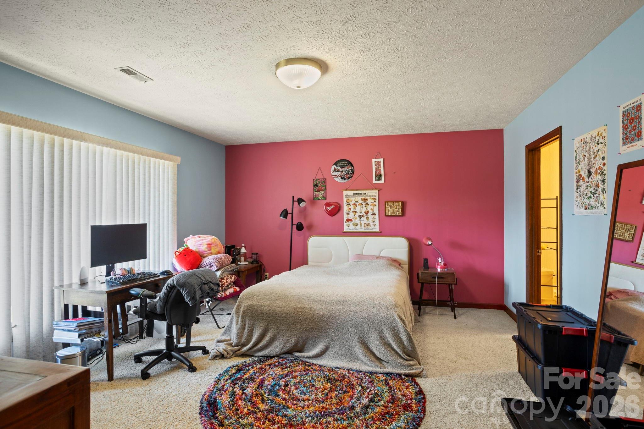 404 Browning Road Hendersonville, NC 28791 - Photo 28 of 46 a bedroom with a bed and flat screen tv