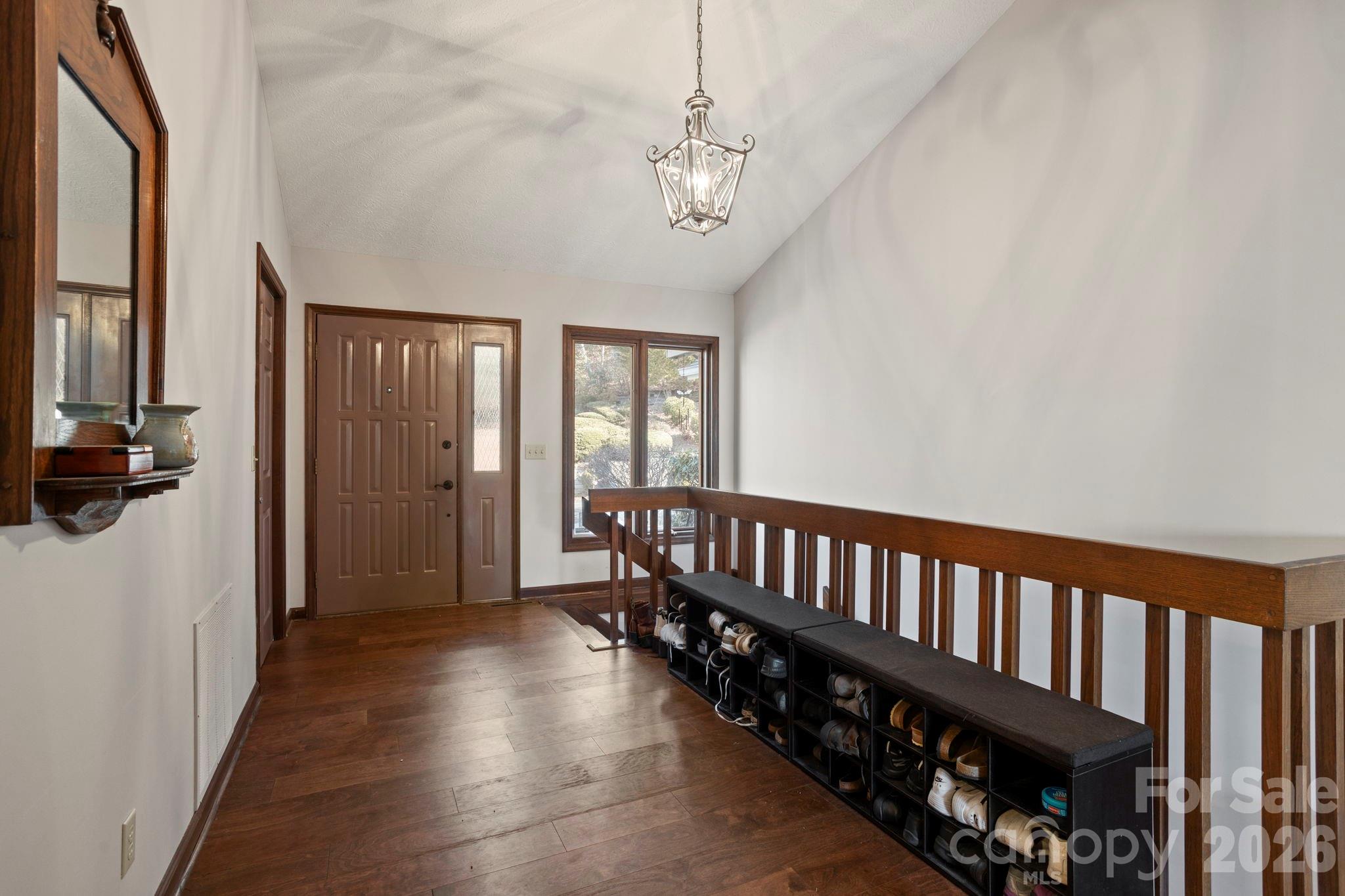 404 Browning Road Hendersonville, NC 28791 - Photo 4 of 46 a view of a hallway with wooden floor and windows