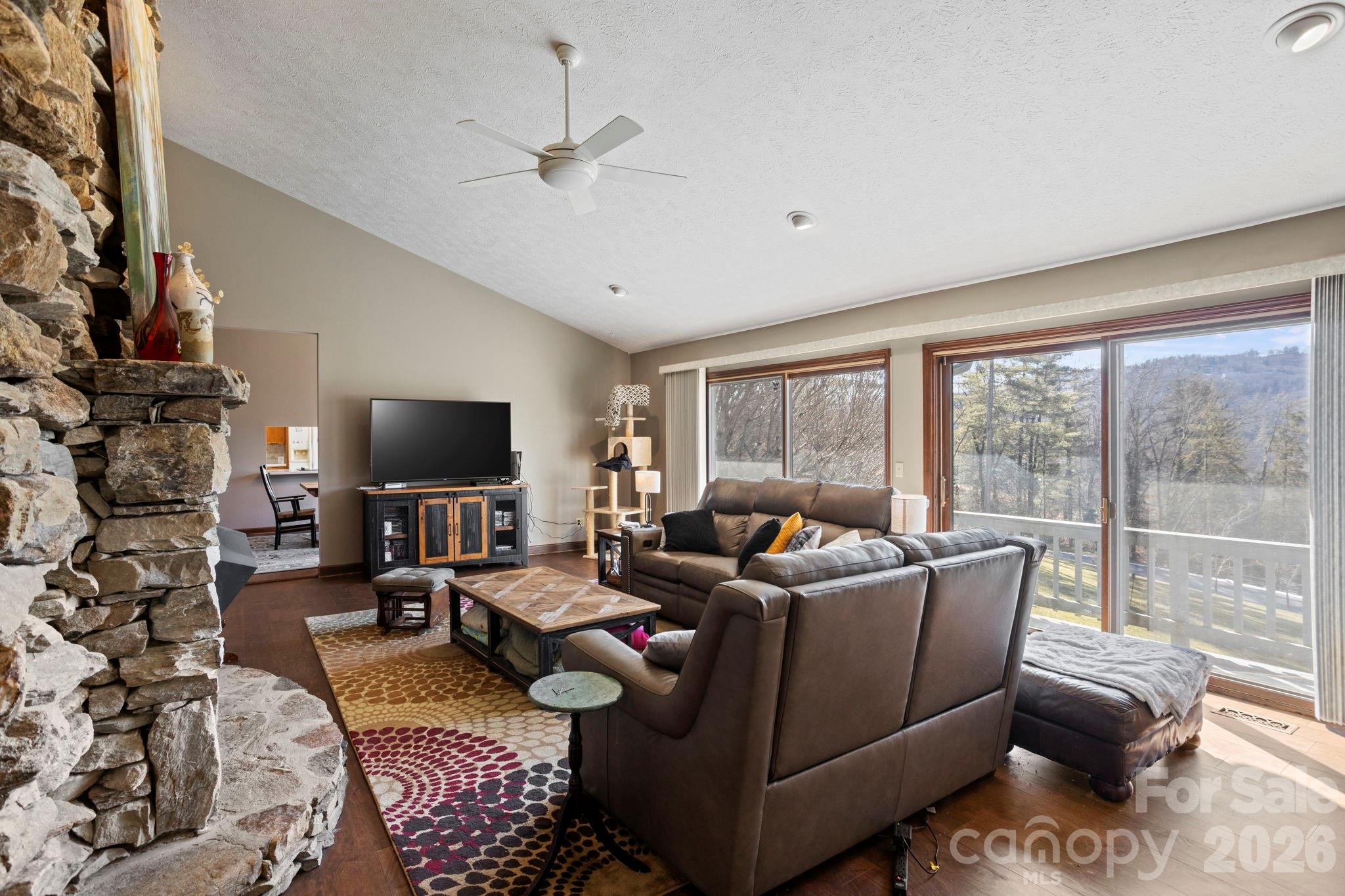 404 Browning Road Hendersonville, NC 28791 - Photo 5 of 46 a living room with furniture a flat screen tv and a large window