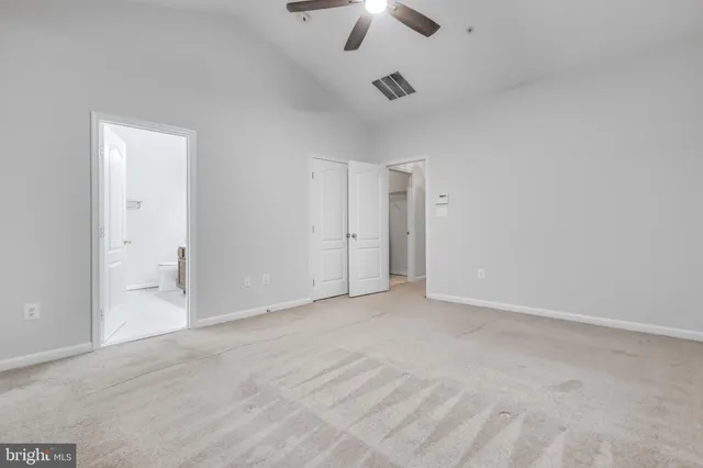 a view of an empty room with a ceiling fan