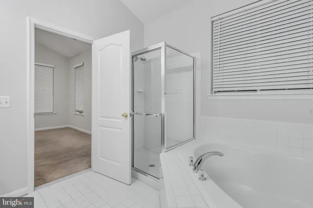 a bathroom with a tub shower and a sink
