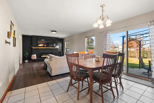 a dining room with furniture a chandelier and window