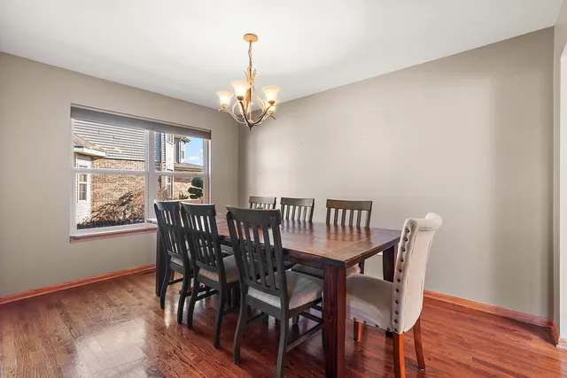 a view of a dining room with furniture wooden floor and chandelier