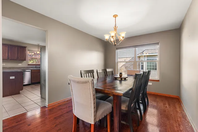 a view of a dining room with furniture wooden floor and chandelier