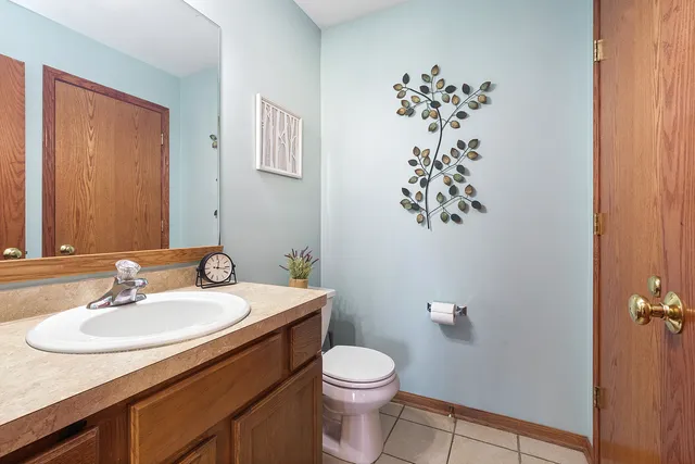 a bathroom with a sink mirror and toilet