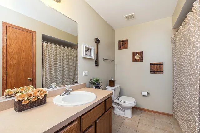 a bathroom with a sink mirror and toilet