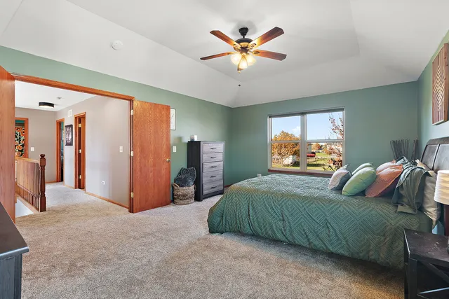 a bedroom with a large bed and a chandelier