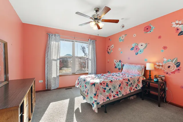 a bedroom with a bed and a window with the dresser