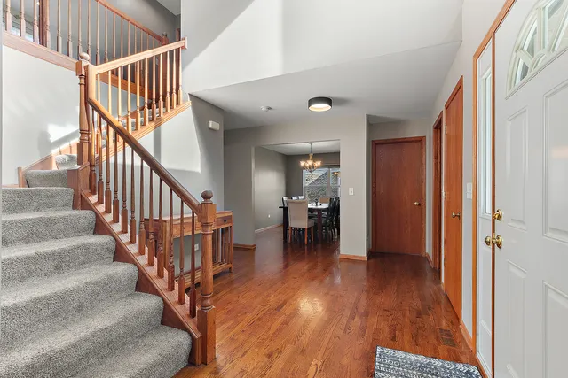 a view of entryway and hall with wooden floor