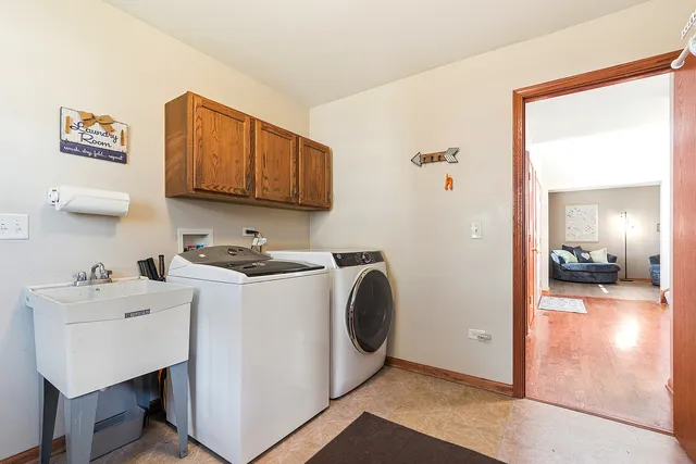 a view of a kitchen with sink washer and dryer