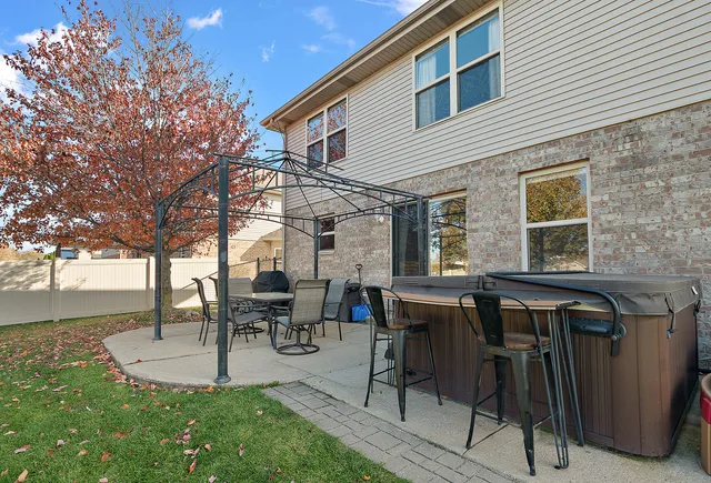 a view of a patio with table and chairs and garden