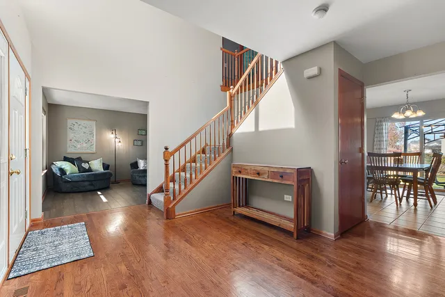 a view of entryway livingroom and hall with wooden floor