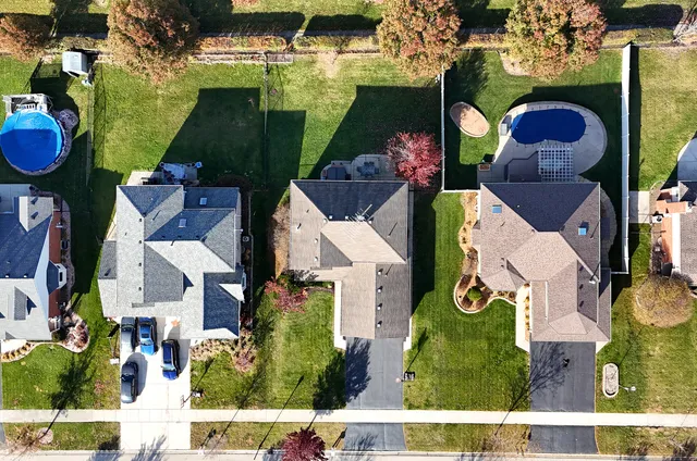 an aerial view of houses with yard