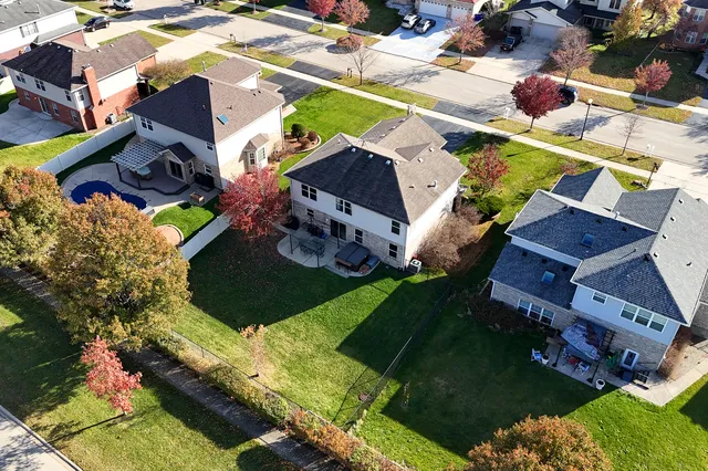 an aerial view of a house with a yard basket ball court and outdoor seating