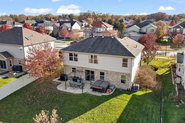 a aerial view of a house with swimming pool and a yard