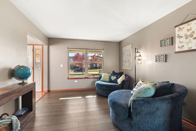 a living room with furniture a couch and a large window