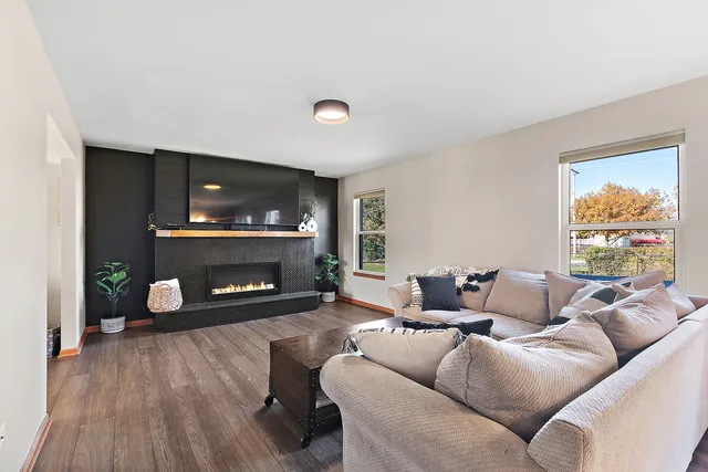 a living room with furniture and a fireplace