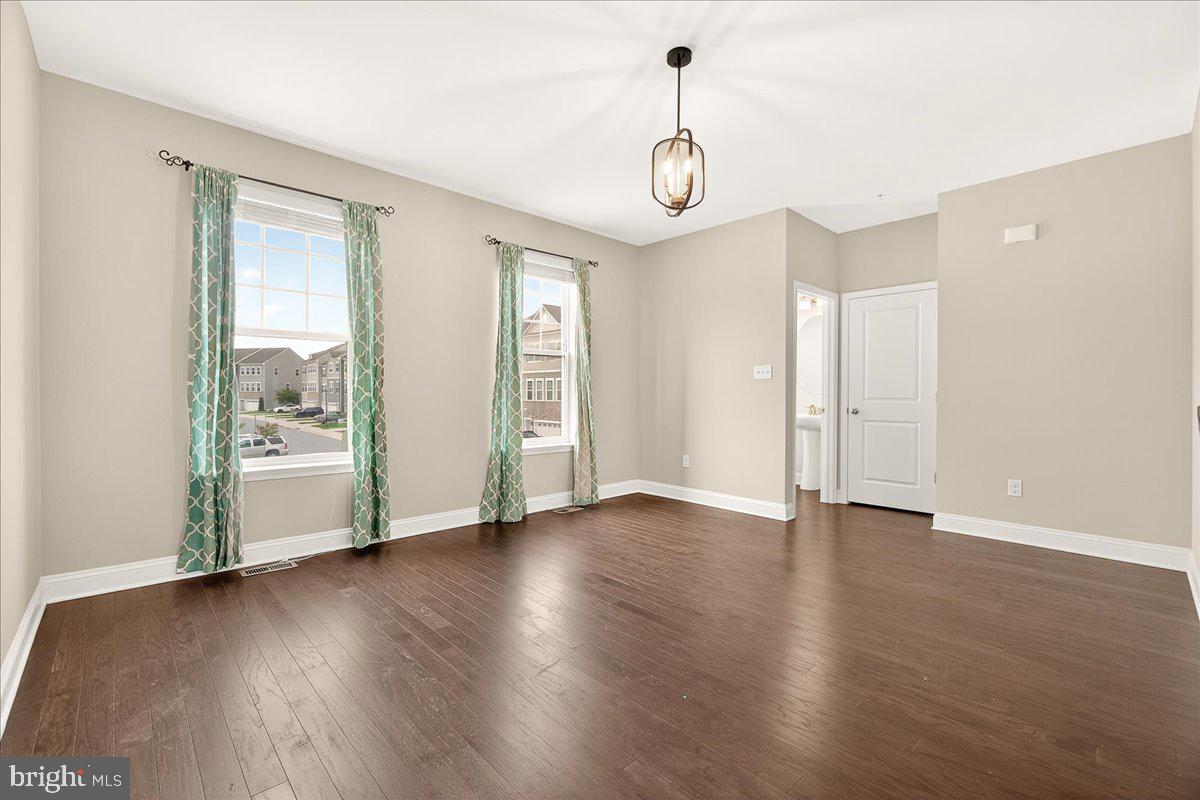 4654 Cambria Road Frederick, MD 21703 - Photo 14 of 55 a view of an empty room with window and wooden floor