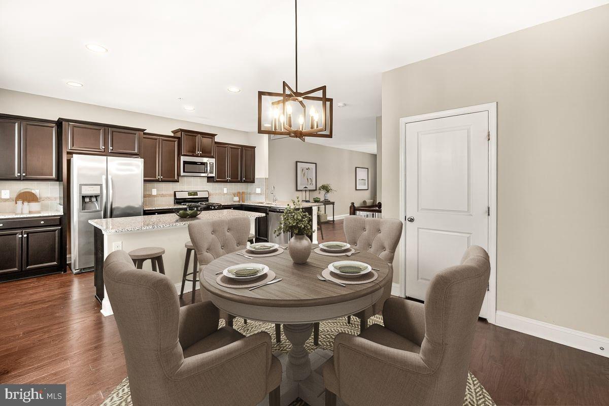 4654 Cambria Road Frederick, MD 21703 - Photo 9 of 55 a view of a dining room with furniture and wooden floor