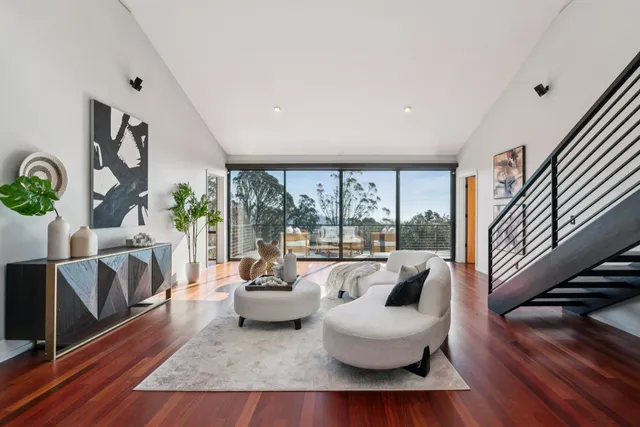 a living room with furniture and a floor to ceiling window