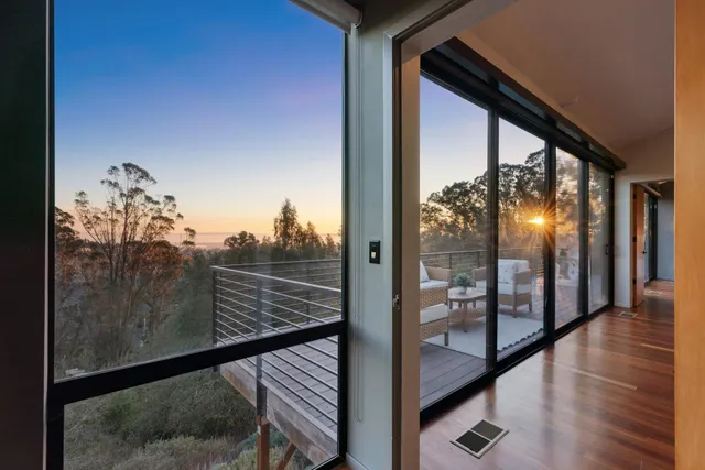 a view of a roof deck with couches and sky view