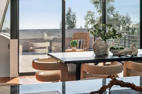 a outdoor dining space with furniture and potted plants