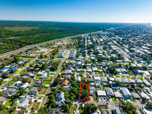 an aerial view of a houses with a yard