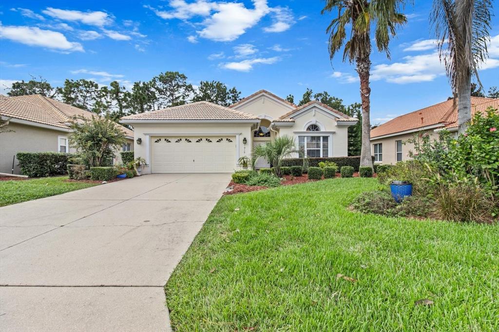 1019 West Diamond Shore Loop, Unit 3 Hernando, FL 34442 - Photo 1 of 1 a view of a white house with a big yard and potted plants
