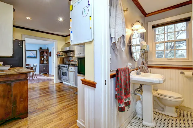 a bathroom with a sink toilet and a mirror