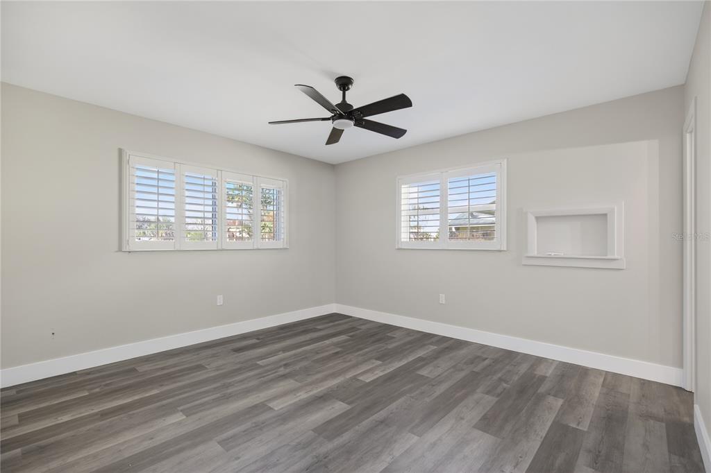1503 Canal Court Tavares, FL 32778 - Photo 20 of 41 a view of a room with wooden floor and a ceiling fan