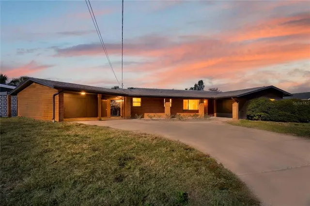 a view of a house next to a yard