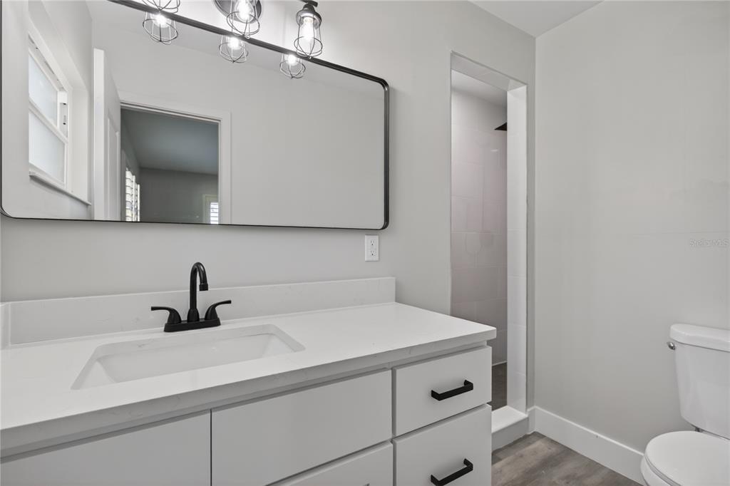 1503 Canal Court Tavares, FL 32778 - Photo 23 of 41 a bathroom with a sink and a mirror
