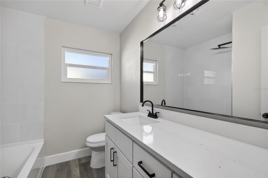 1503 Canal Court Tavares, FL 32778 - Photo 25 of 41 a bathroom with a sink a toilet and shower