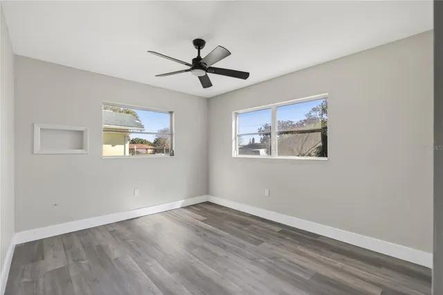 a view of an empty room with wooden floor