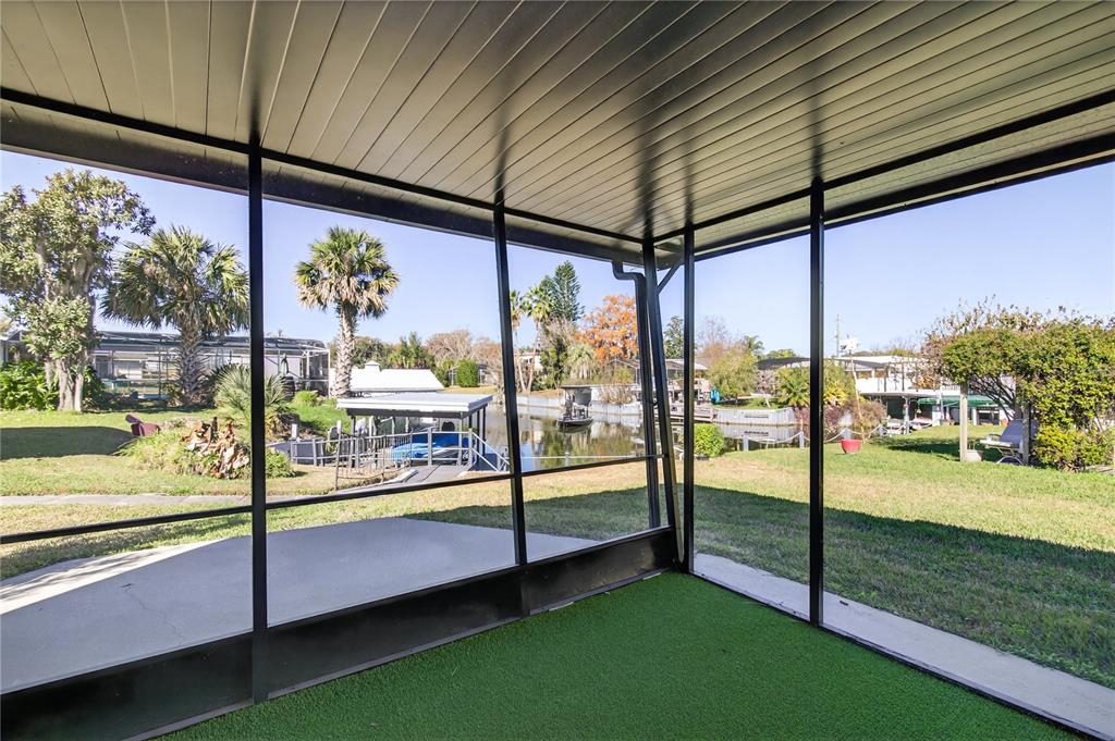 1503 Canal Court Tavares, FL 32778 - Photo 28 of 41 a view of a porch with a table and chairs