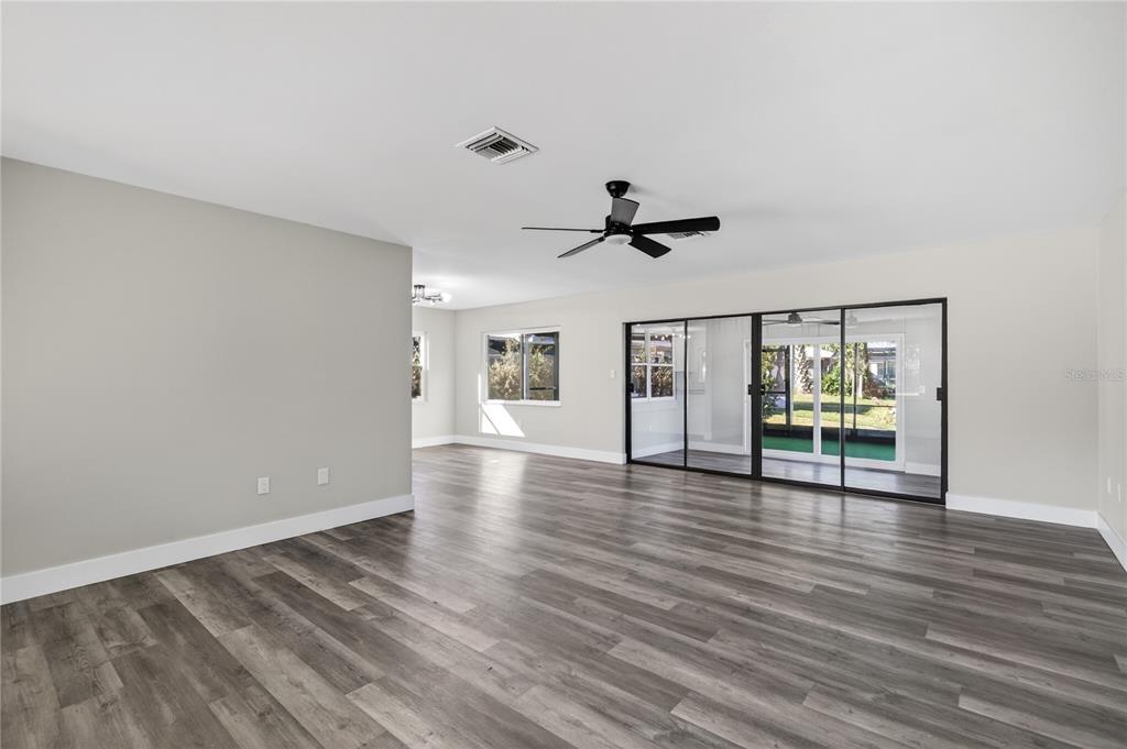 1503 Canal Court Tavares, FL 32778 - Photo 6 of 41 a view of empty room with wooden floor and fan