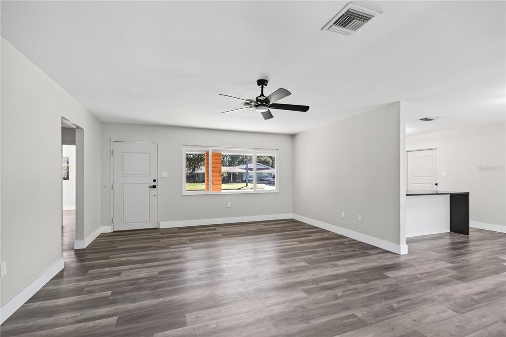 1503 Canal Court Tavares, FL 32778 - Photo 7 of 41 wooden floor in an empty room with a window