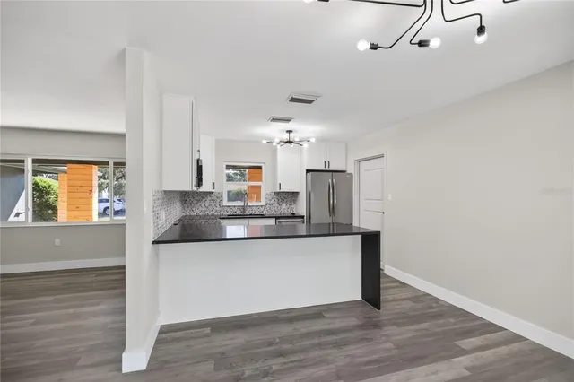a kitchen with stainless steel appliances granite countertop a sink and cabinets