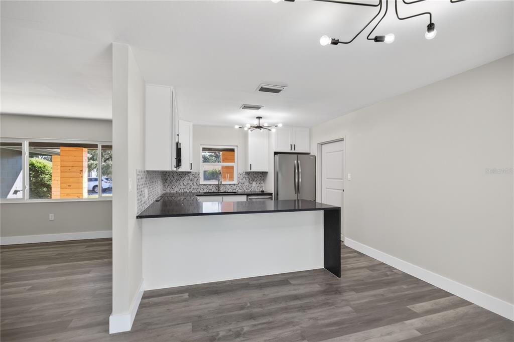 1503 Canal Court Tavares, FL 32778 - Photo 10 of 41 a kitchen with stainless steel appliances granite countertop a sink and cabinets