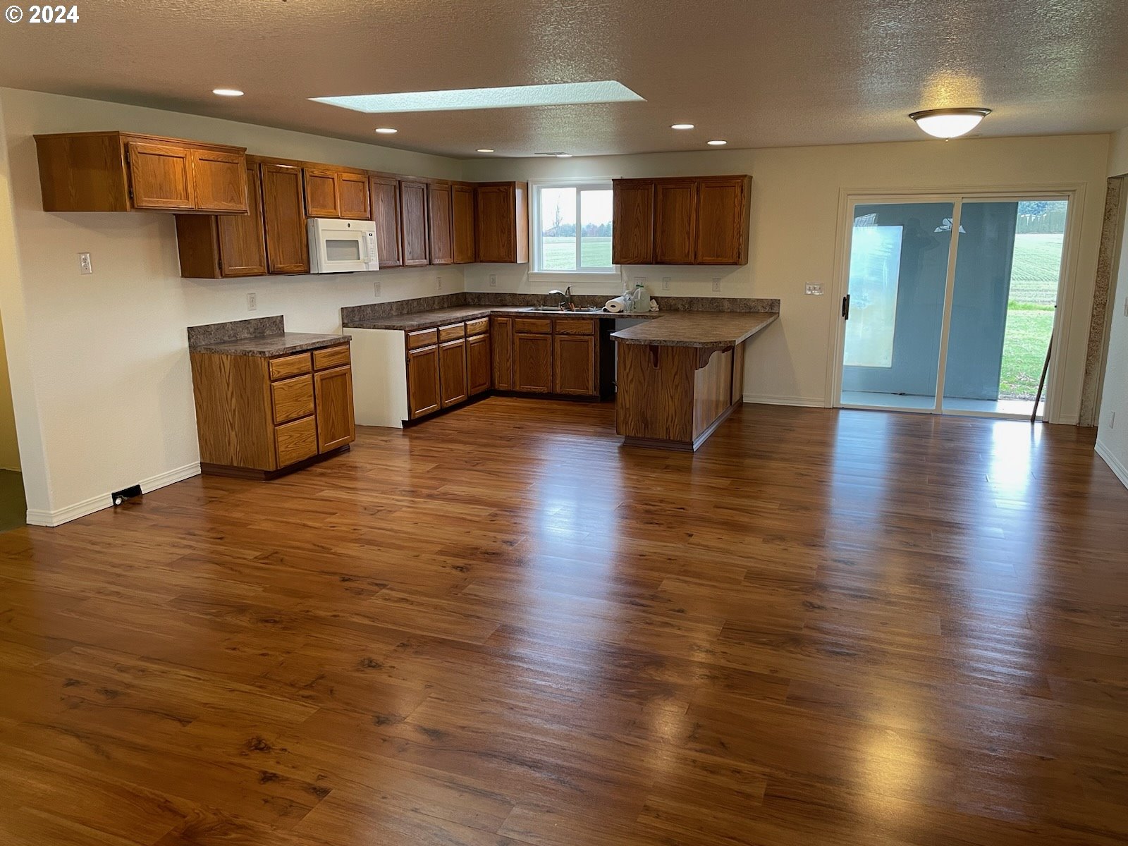 4701 Concomly Road Northeast Gervais, OR 97026 - Photo 5 of 33 a kitchen with stainless steel appliances granite countertop a sink and cabinets