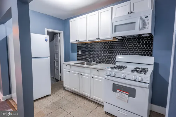a kitchen with a stove and a refrigerator