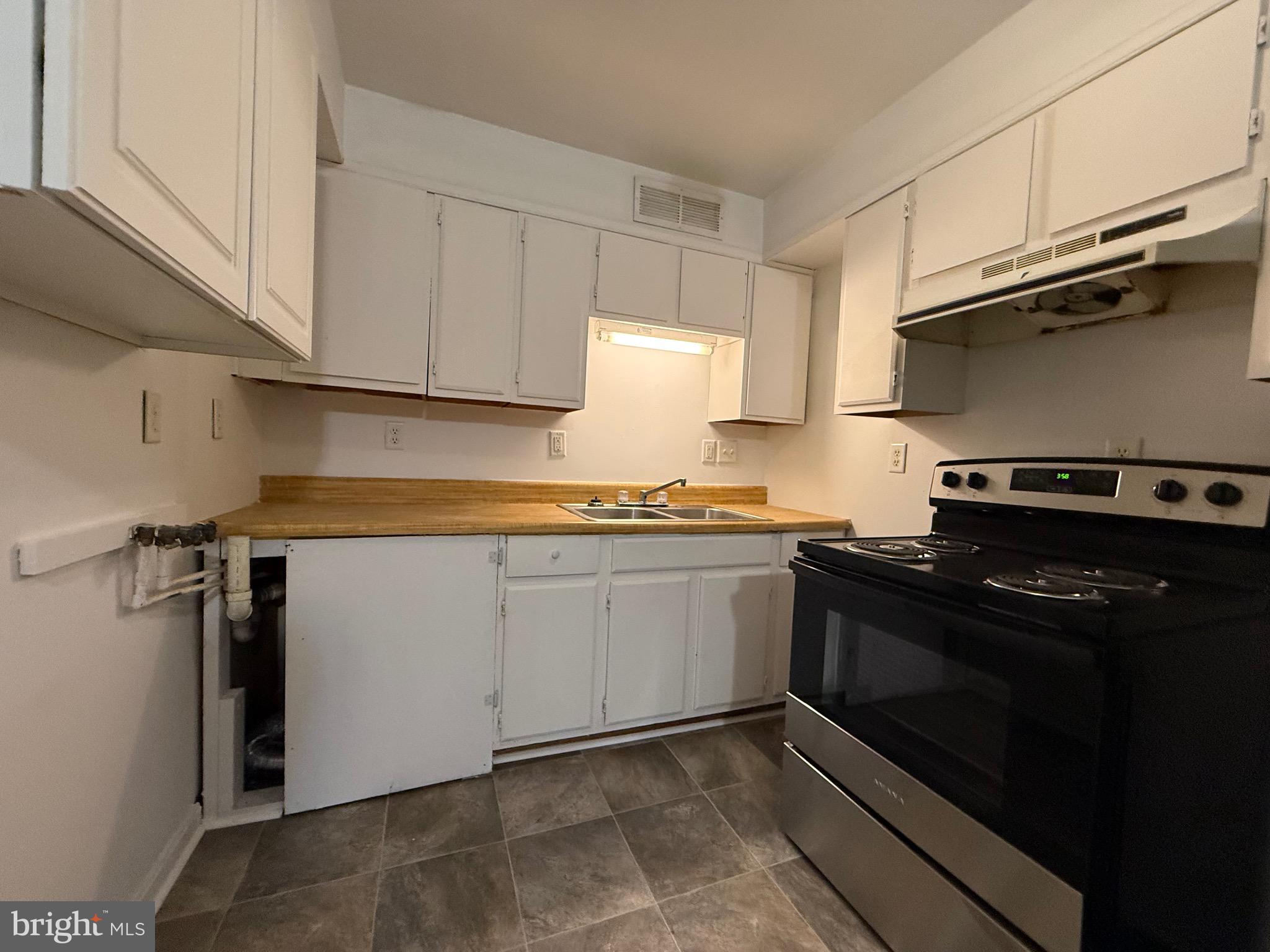 2315 Oak Park Road, Unit B Madison, VA 22727 - Photo 5 of 7 a kitchen with stainless steel appliances granite countertop a sink stove and cabinets