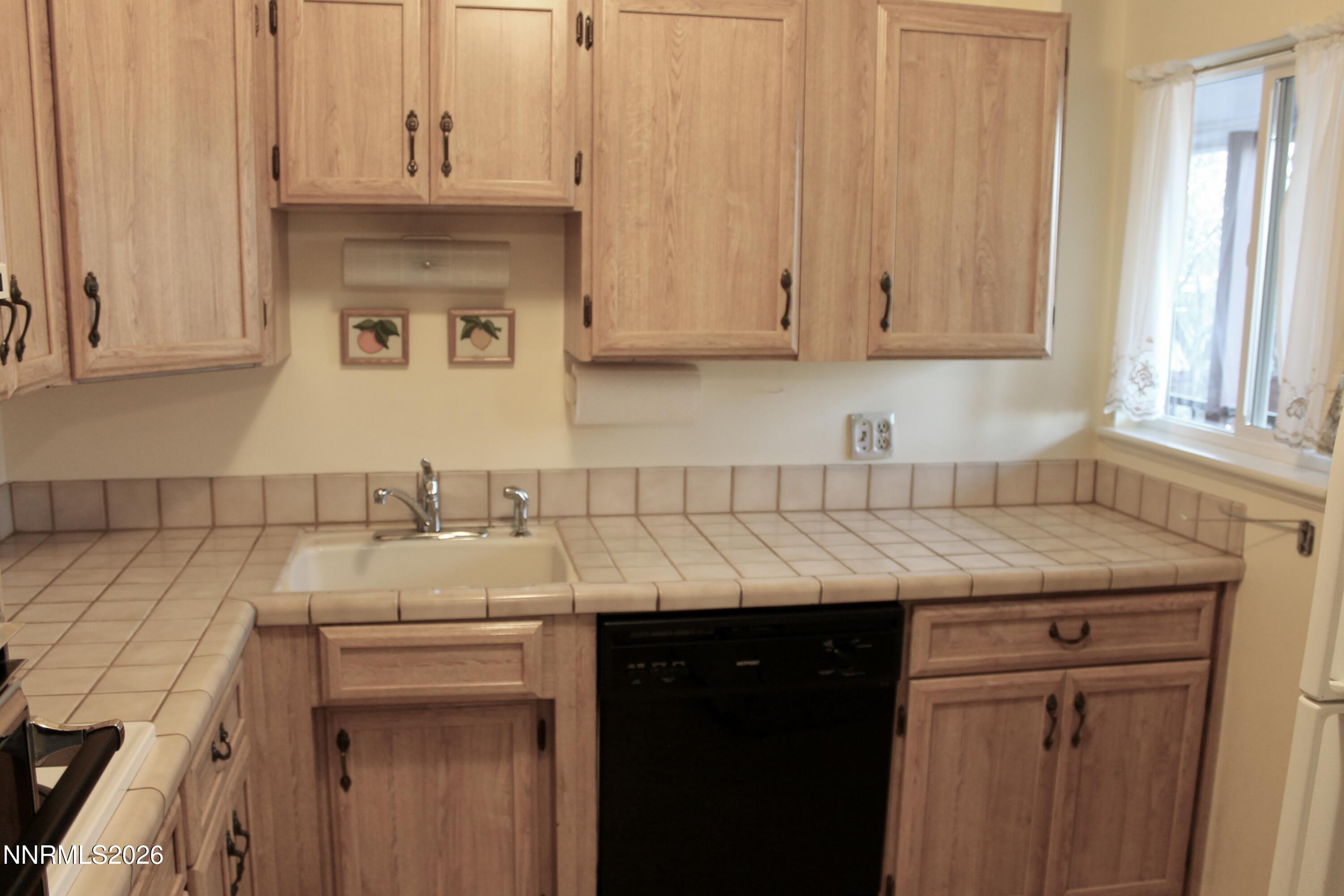 1940 4th Street, Unit 46 Sparks, NV 89431 - Photo 10 of 21 a kitchen with a sink and cabinets