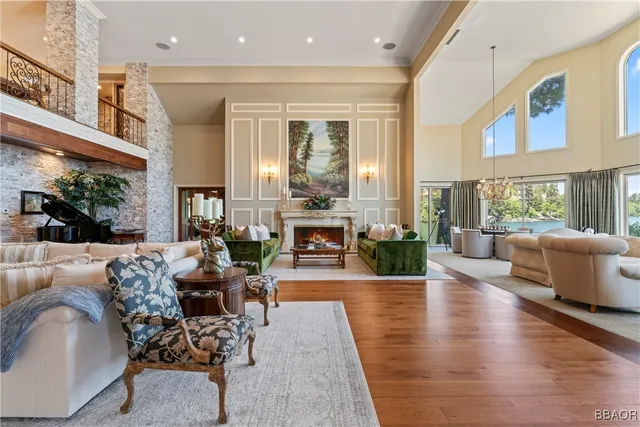 a living room with fireplace furniture and a large window